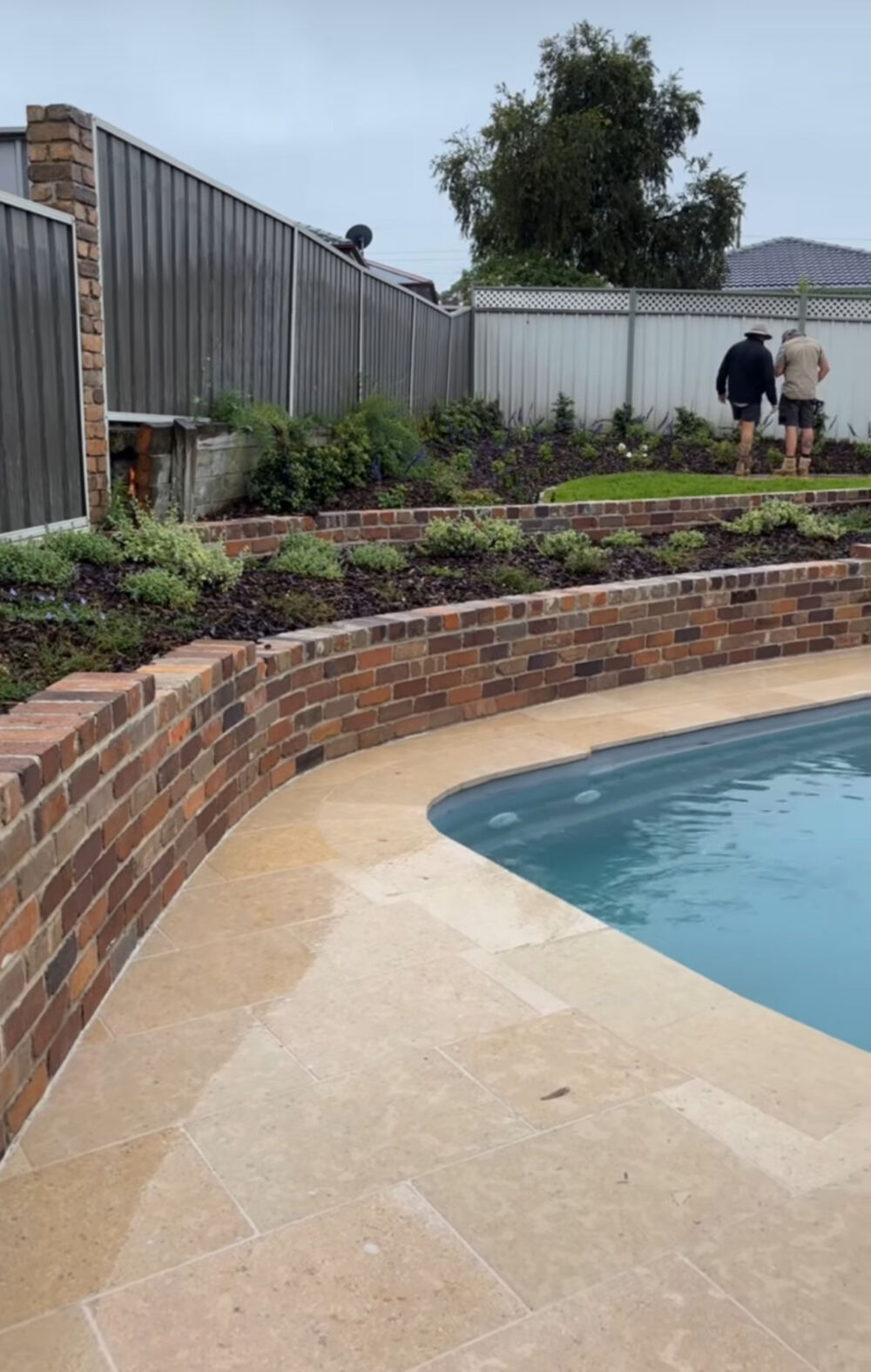 Amalfi Limestone around a pool with Recycled Bricks